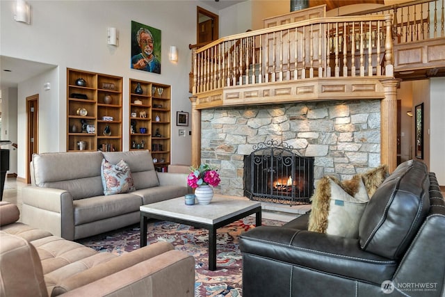 living area featuring a fireplace and a towering ceiling