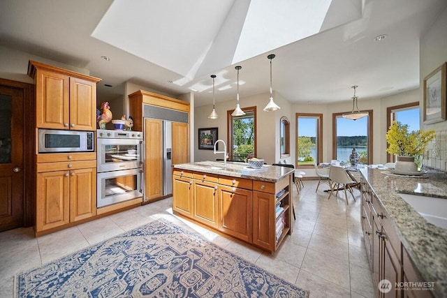 kitchen featuring open shelves, appliances with stainless steel finishes, hanging light fixtures, and light stone countertops