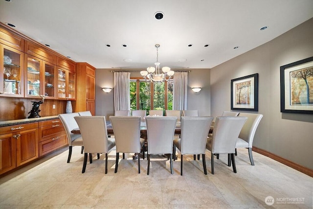 dining room featuring baseboards, recessed lighting, and a notable chandelier