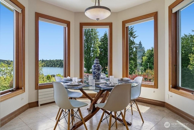 sunroom / solarium featuring a water view