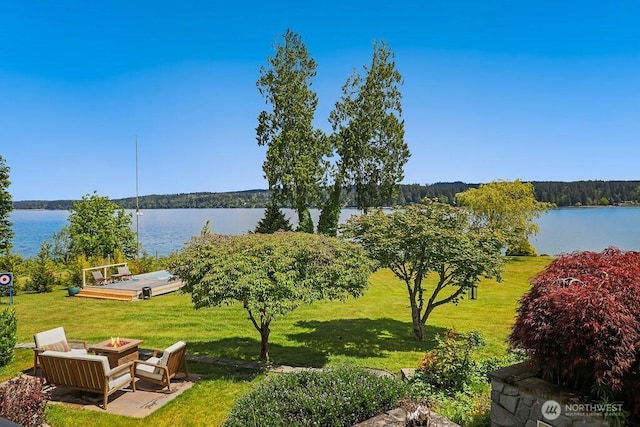 property view of water with a fire pit