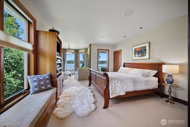 bedroom with baseboards, recessed lighting, and light colored carpet