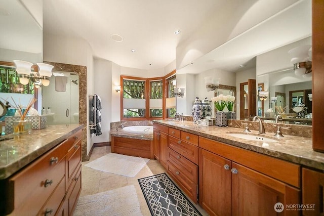 full bathroom with double vanity, a sink, a bath, and tile patterned floors