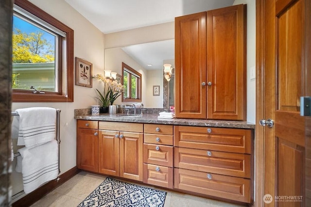 bathroom featuring tile patterned flooring, vanity, and baseboards