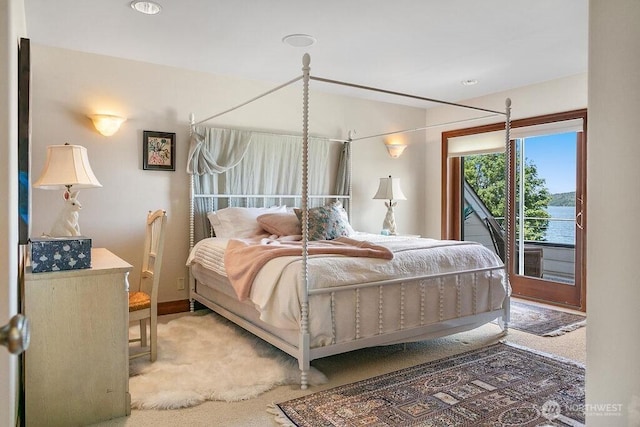 bedroom featuring access to outside and light colored carpet