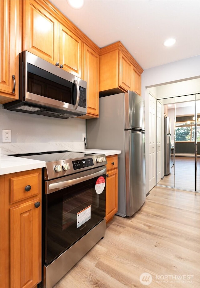 kitchen featuring appliances with stainless steel finishes and light wood-type flooring