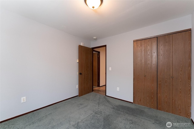 unfurnished bedroom featuring light carpet and a closet