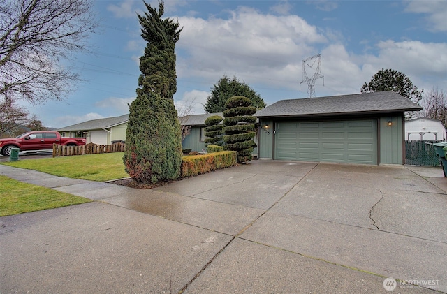 view of front facade with a garage and a front lawn