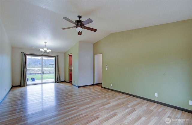 unfurnished room with ceiling fan with notable chandelier, light wood-type flooring, and lofted ceiling