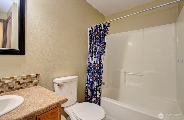 full bathroom with decorative backsplash, vanity, toilet, and shower / bath combo