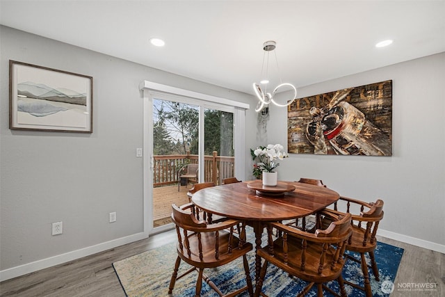 dining room featuring recessed lighting, a notable chandelier, baseboards, and wood finished floors