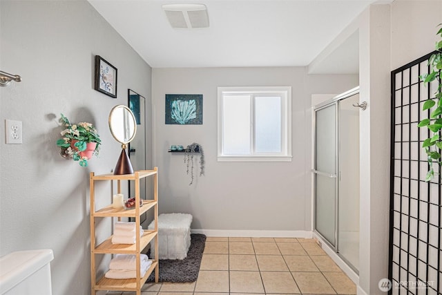 full bathroom with toilet, visible vents, baseboards, tile patterned floors, and a stall shower