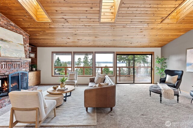 living room featuring light carpet, lofted ceiling with skylight, a fireplace, and a healthy amount of sunlight