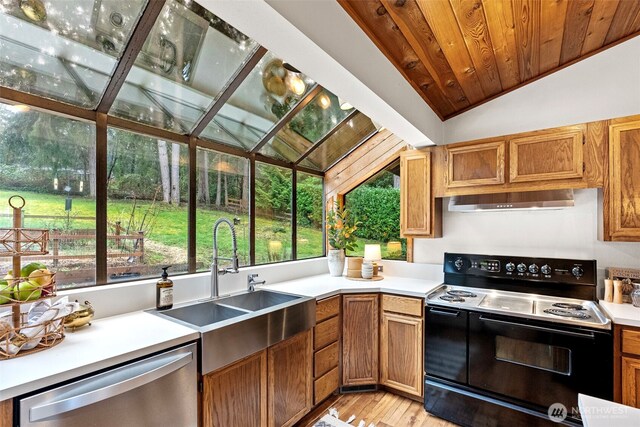 kitchen featuring dishwasher, light countertops, electric range, and range hood