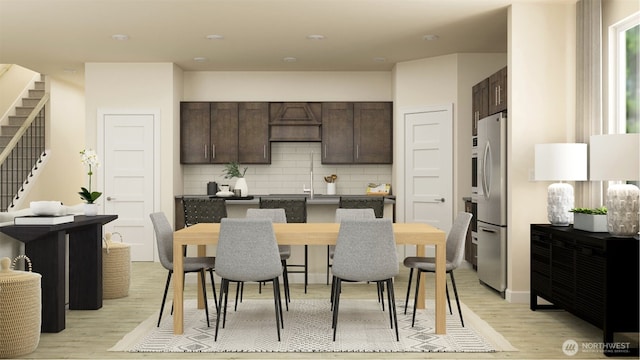 kitchen with stainless steel fridge, dark brown cabinetry, and light hardwood / wood-style flooring