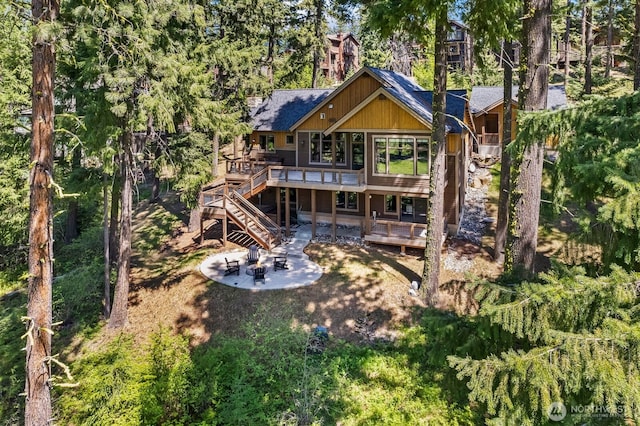 262 Black Nugget Ln, Cle Elum, WA 98922 - back of property with a deck, a patio area, stairs, and roof with shingles
