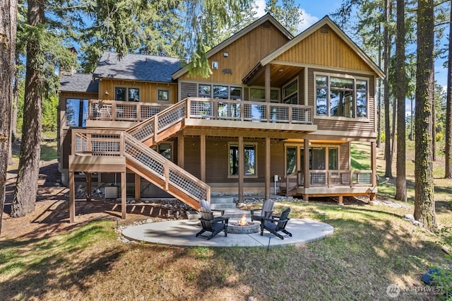 262 Black Nugget Ln, Cle Elum, WA 98922 - rear view of house with a fire pit, a patio, a wooden deck, stairway, and a yard