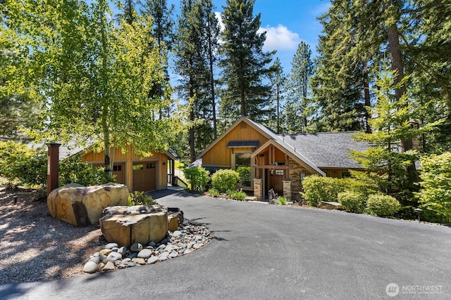 262 Black Nugget Ln, Cle Elum, WA 98922 - view of front of property with stone siding, a shingled roof, driveway, and an outbuilding