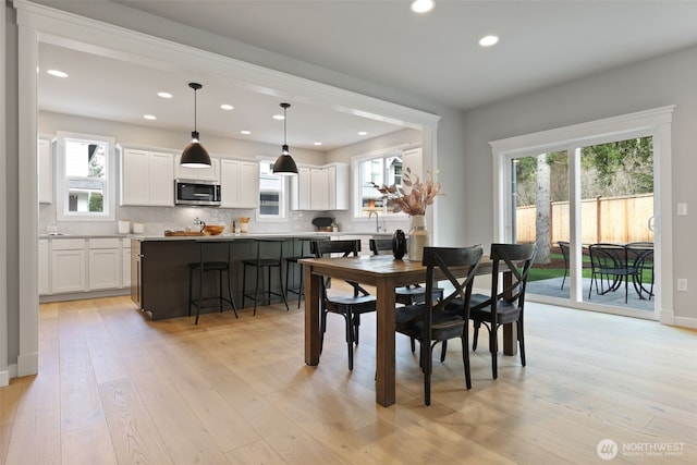 dining area with recessed lighting, baseboards, and light wood finished floors