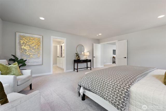 bedroom featuring recessed lighting, light colored carpet, ensuite bath, and baseboards