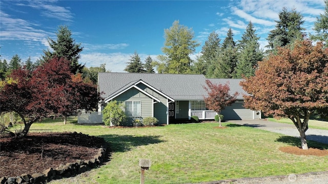 view of front of home featuring driveway, an attached garage, board and batten siding, and a front yard