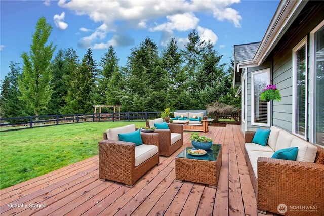 deck with a fenced backyard, outdoor lounge area, and a yard