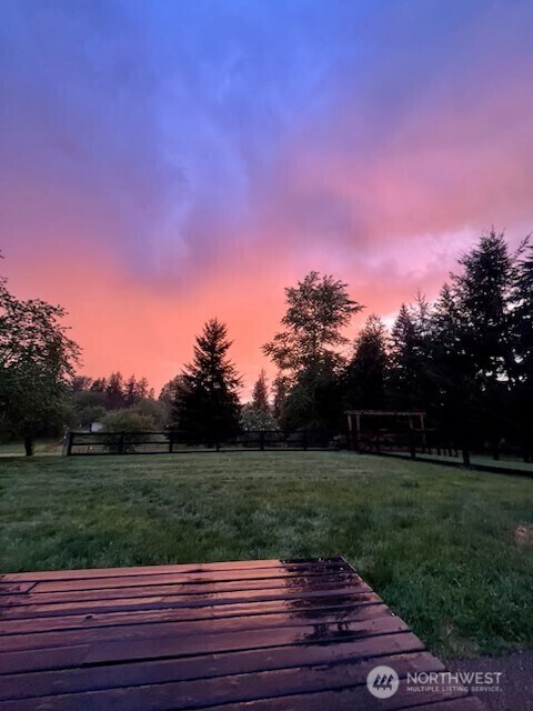 yard at dusk with a deck