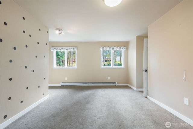 unfurnished room with carpet floors, baseboards, and a baseboard heating unit