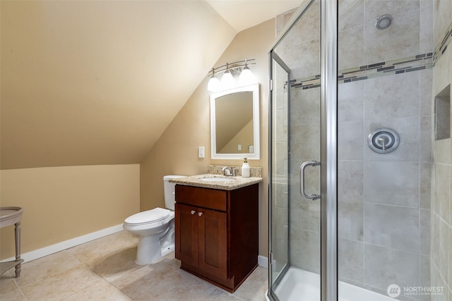 full bath with a shower stall, baseboards, vaulted ceiling, and vanity