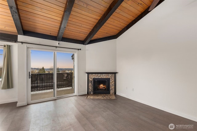 unfurnished living room featuring vaulted ceiling with beams, a fireplace with flush hearth, wood finished floors, and baseboards