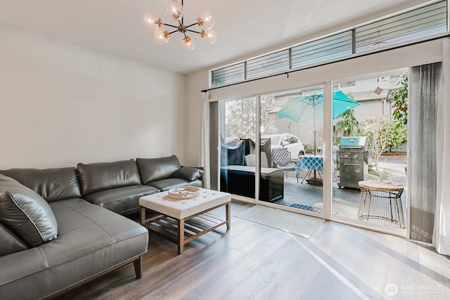 living room featuring hardwood / wood-style flooring and an inviting chandelier