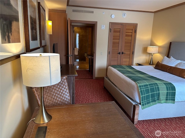 bedroom with ornamental molding, visible vents, and carpet flooring