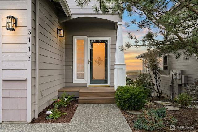 view of exterior entry at dusk