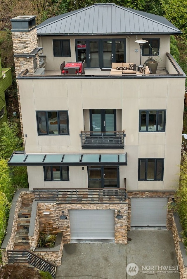 view of building exterior with an attached garage and driveway