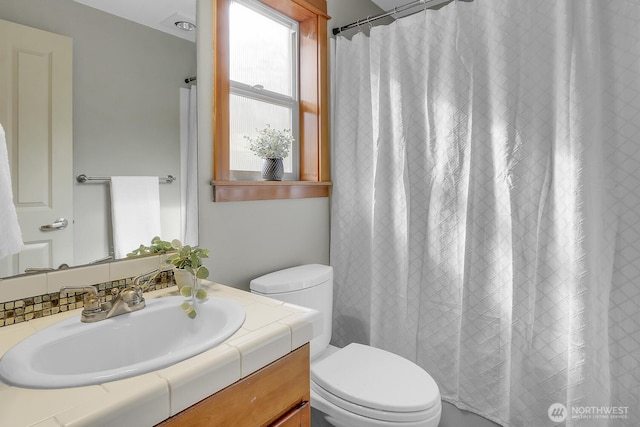 bathroom with toilet and vanity