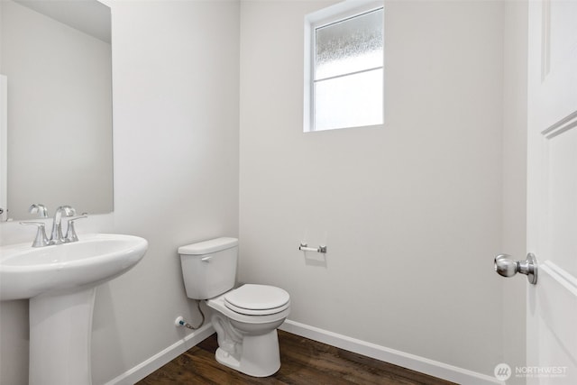 bathroom featuring sink, toilet, and wood-type flooring