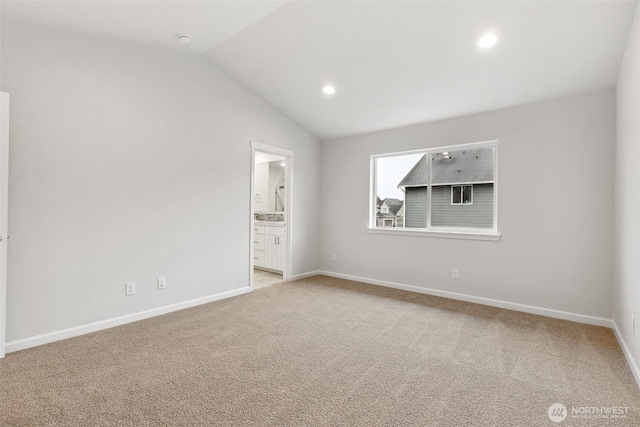 empty room featuring lofted ceiling and light colored carpet