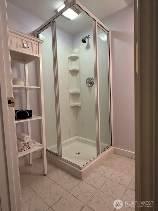 bathroom featuring a shower with shower door