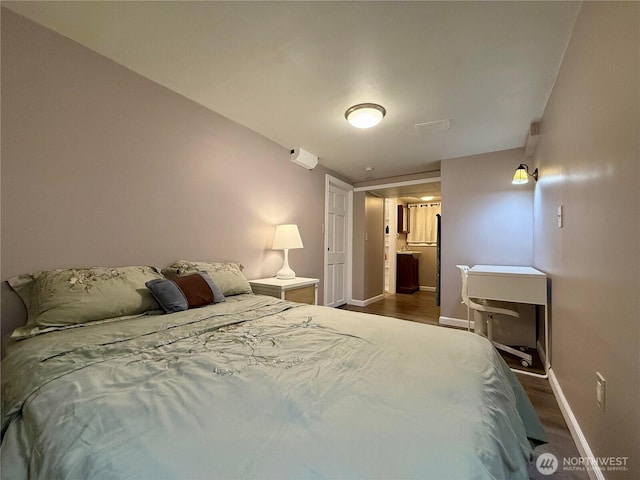 bedroom with dark hardwood / wood-style floors