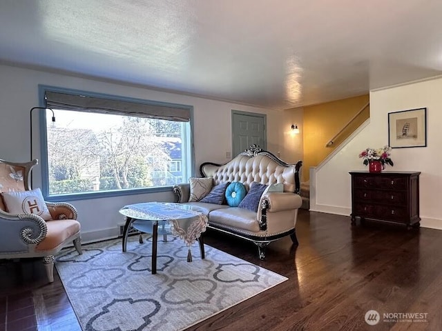 living area with stairway, wood finished floors, and baseboards