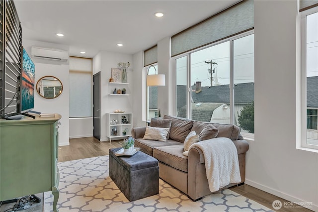 living area with recessed lighting, wood finished floors, plenty of natural light, and a wall mounted AC