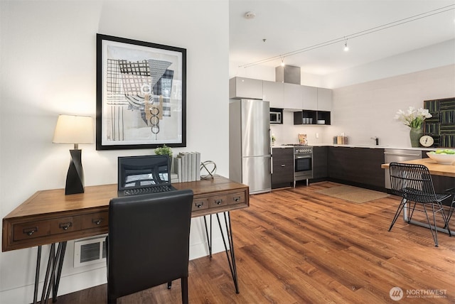 interior space featuring stainless steel appliances, wood finished floors, visible vents, light countertops, and modern cabinets