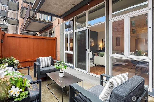 view of patio featuring an outdoor hangout area and fence