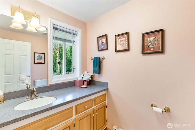 bathroom featuring vanity and toilet