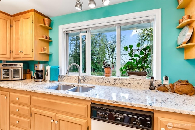 kitchen featuring dishwashing machine, plenty of natural light, sink, and light brown cabinetry