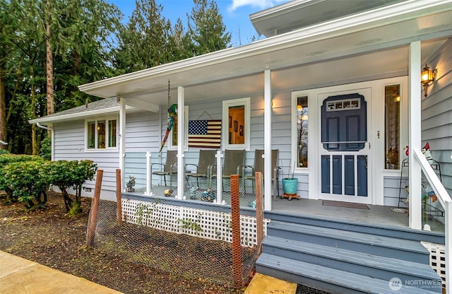 view of exterior entry featuring covered porch