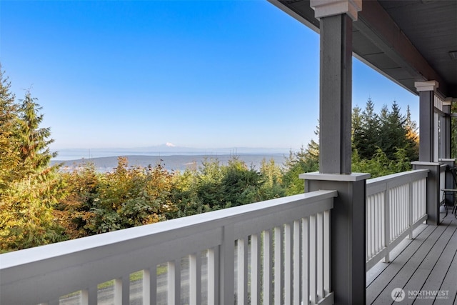 wooden terrace featuring a water view