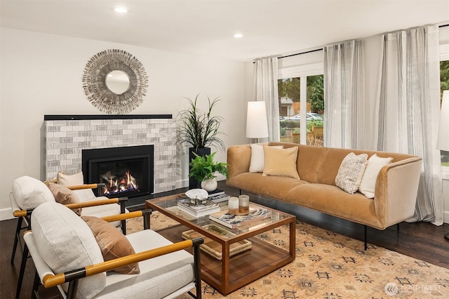 living area with a fireplace, wood finished floors, and recessed lighting