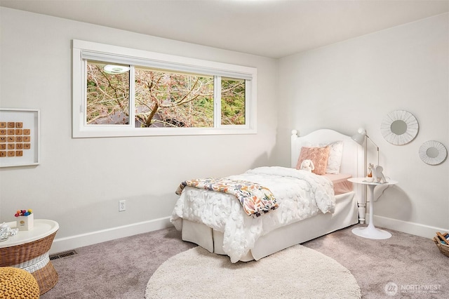 carpeted bedroom with visible vents and baseboards