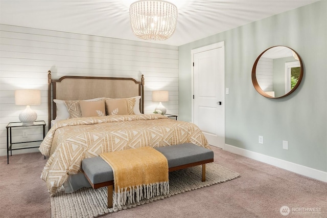 bedroom featuring an inviting chandelier, baseboards, and carpet flooring